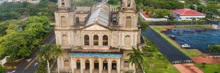 Aerial shot of the Old Cathedral of Managua, showcasing its historic architecture and surrounding cityscape.